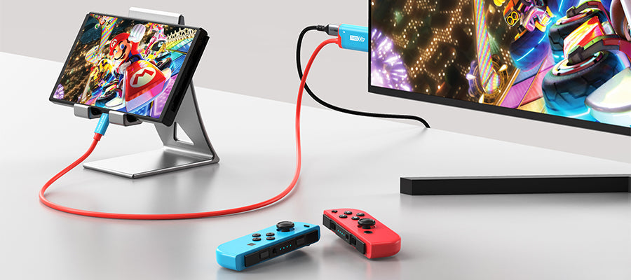 USB-C to HDMI mini dock connecting Nintendo Switch to TV displaying Mario Kart with Joy-Con controllers