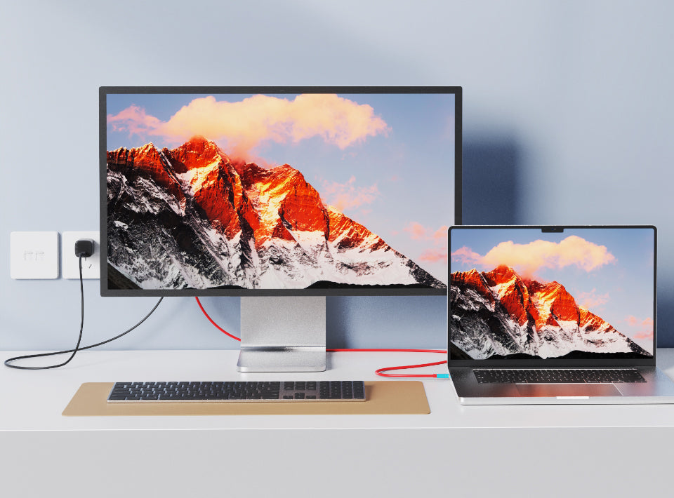 Laptop connected to external monitor with Cabletime USB-C to HDMI cable adapter displaying mountain landscape while charging the laptop simultaneously