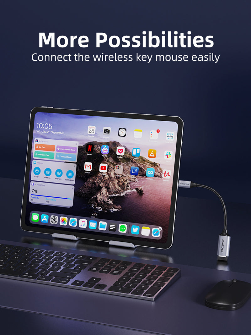 CableTime 10Gbps USB-C to USB-A adapter connected to an iPad, enabling use of a wireless keyboard and mouse for easier multitasking.