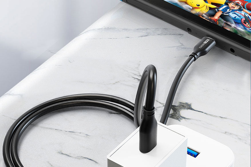 Nintendo Switch connected to a separate power adapter using the black USB-C to USB-C charging cable.